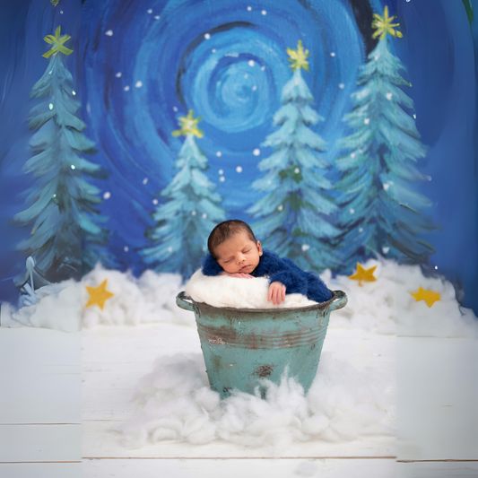 Sleeping baby in a cozy bucket with wonderful winter star christmas background